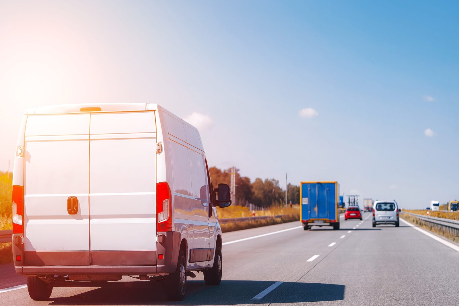 White van driving on highway road
